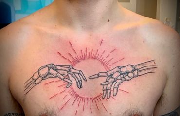 Tattoo of skeleton hands reaching for each other
