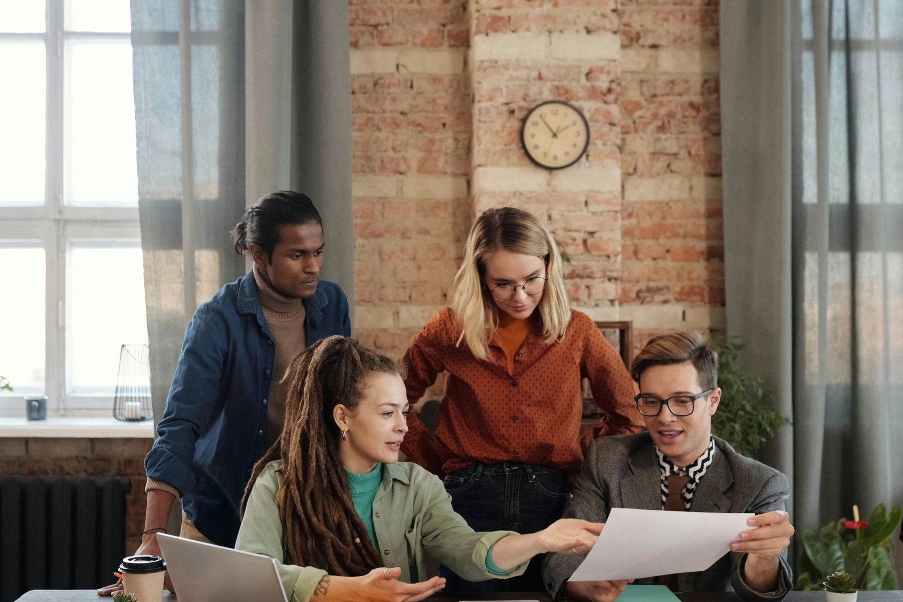 Group of people discussing marketing plans. Pexel image by Mikael Blomkvist