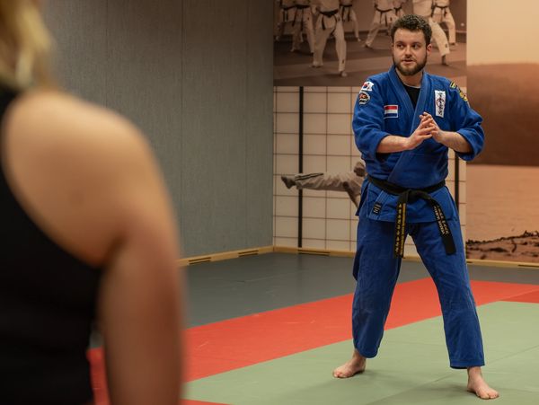 Gongkwon Yusul teacher stands in front of a student and explains a technique.