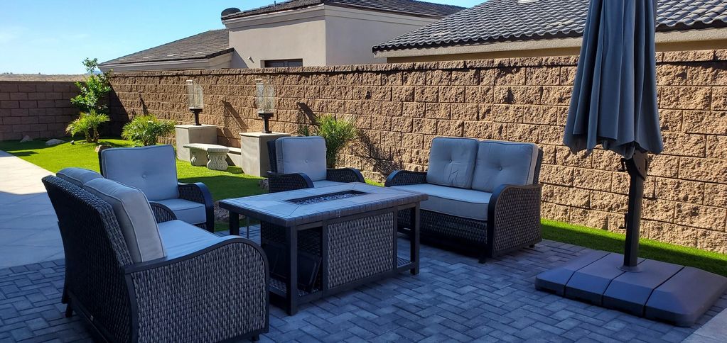 Outdoor patio with seating and umbrella.