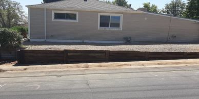 Retaining wall made of very heavy railroad ties and rebar. We also build retaining walls with stone.