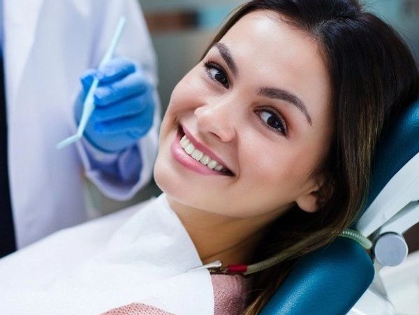 Smiling woman in dental chair during a checkup.
