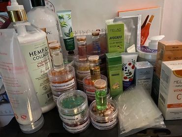 A collection of skincare products including collagen lotion, essence capsules, masks, and vitamin supplements.