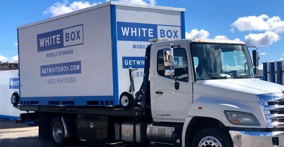 White Box Storage Container Loaded On A Delivery Truck