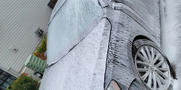 Car covered in foam during a wash.