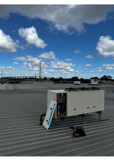 Our team fitting off a coolroom condensor on a rooftop in Port Melbourne powering up our customers n