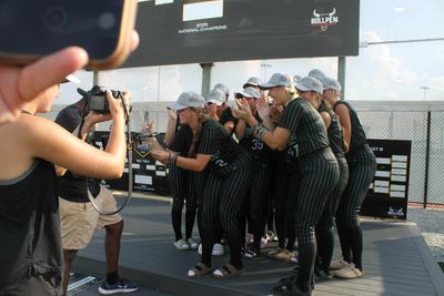 Midwest Speed Softball team posing for a photo after winning a championship.