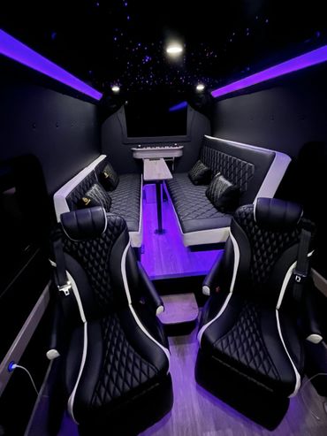 Luxurious black interior with LED purple lighting and quilted seating.