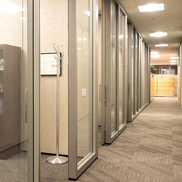 hallway of glass modular walls with sliding doors