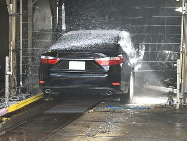 Washing the foam from the surface of the vehicle.