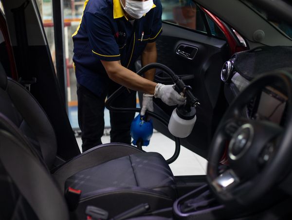 Worker checking the car and cleaning with the equipment
