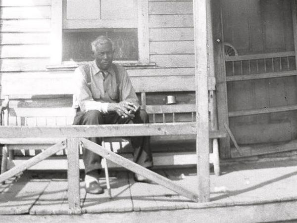 Captain James Campbell sitting on the front porch of his home