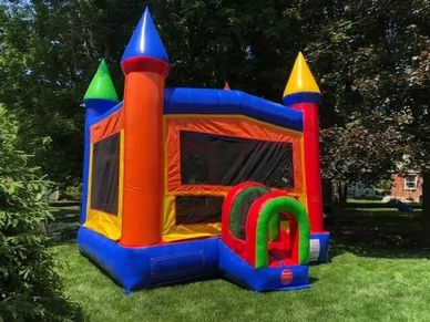 Colorful bounce house available from Cincinnati Bounce House Rentals, set up on a green lawn in Bata