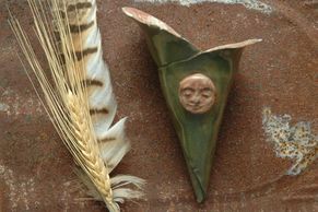 small green stoneware wall cone hanging, flower holder with sun or moon face accent 