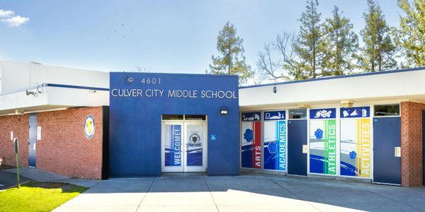 Entrance of Culver City Middle School with colorful academic and activity banners.