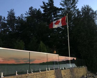 Frameless glass railing Toronto with spigot system.