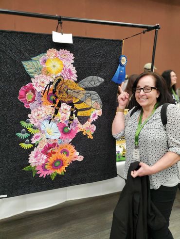 Tina's quilt won first place at the 2024 North American Honey Bee Expo needlecraft category.