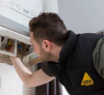 Gas Safe Engineer servicing a boiler