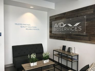 A contemporary frosted lobby sign installed using stand-off hardware. Vinyl credo for balance