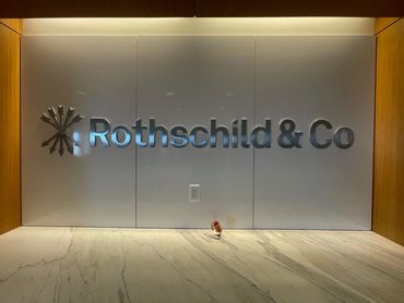 1/2" thick solid aluminum letters, installed using studs into marble tiling.