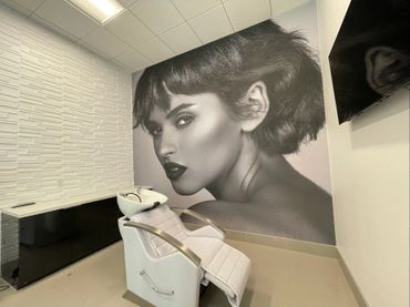 Large wall mural in a salon, installed using built-in pressure-sensitive adhesive.