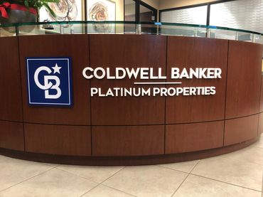 1/2" thick white acrylic lettering, installation on reception desk.