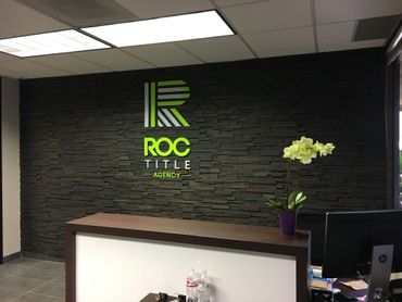 1/4" acrylic lobby sign. Installation on textured accent wall using stand-off hardware.