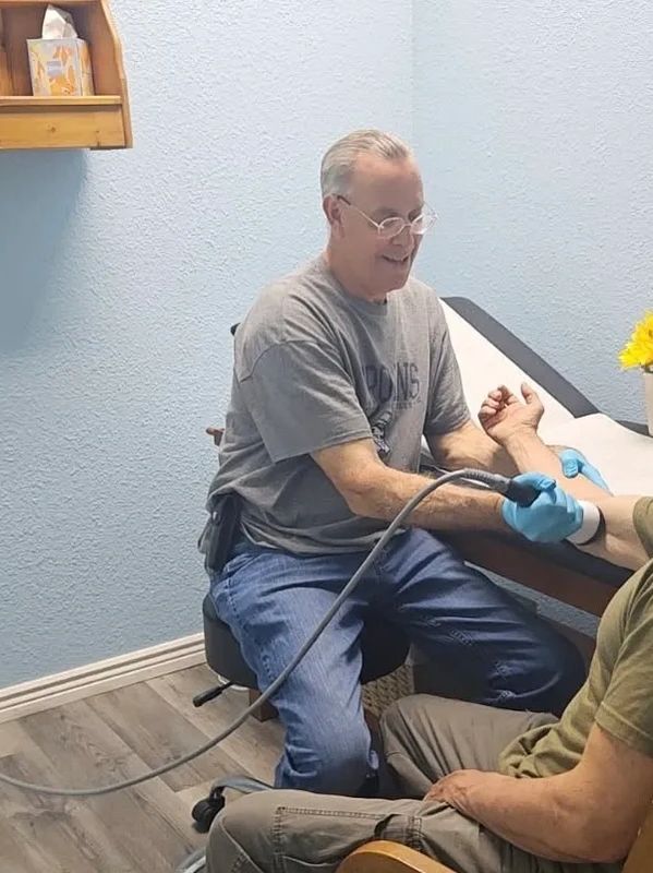 James doing StemWave therapy on a patient.