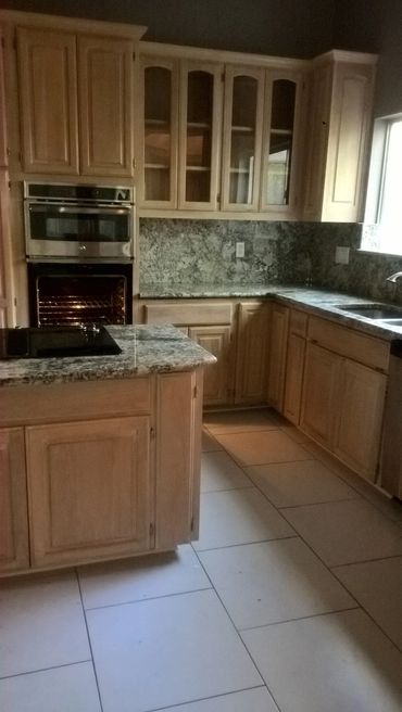 Modern kitchen with wooden cabinets and granite countertops.