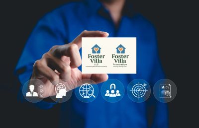 Person holding a card with Foster Villa logos and digital icons.