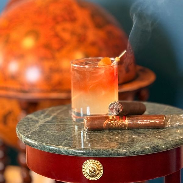 Cocktail and cigars on a marble table