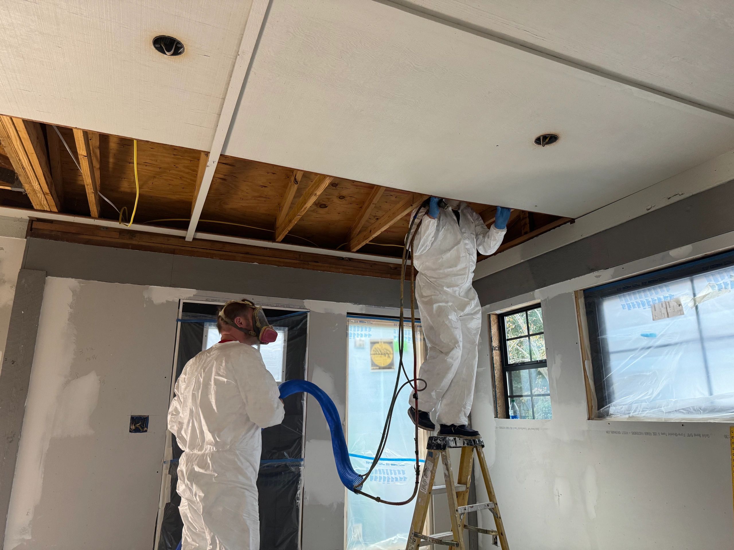 2 people installing spray foam insulation in Pensacola, FL