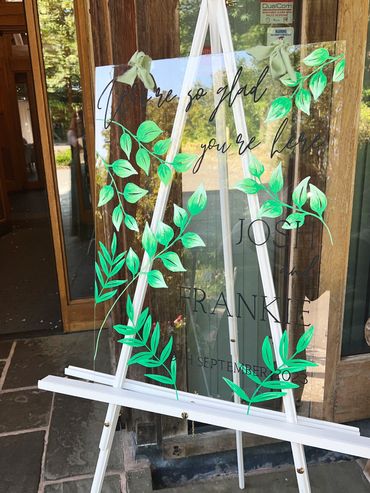 Hand drawn welcome sign with eucalyptus and other foliage