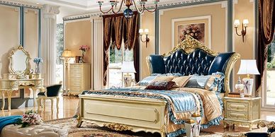 Luxurious classic bedroom with ornate furniture and rich fabrics.