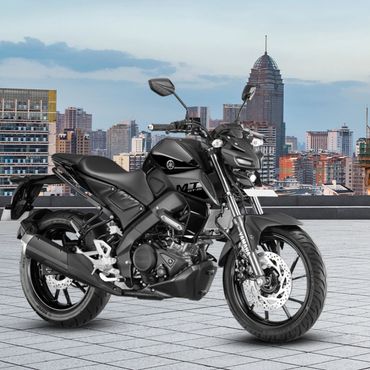 Black Yamaha MT-15 motorcycle parked on a rooftop with cityscape background.