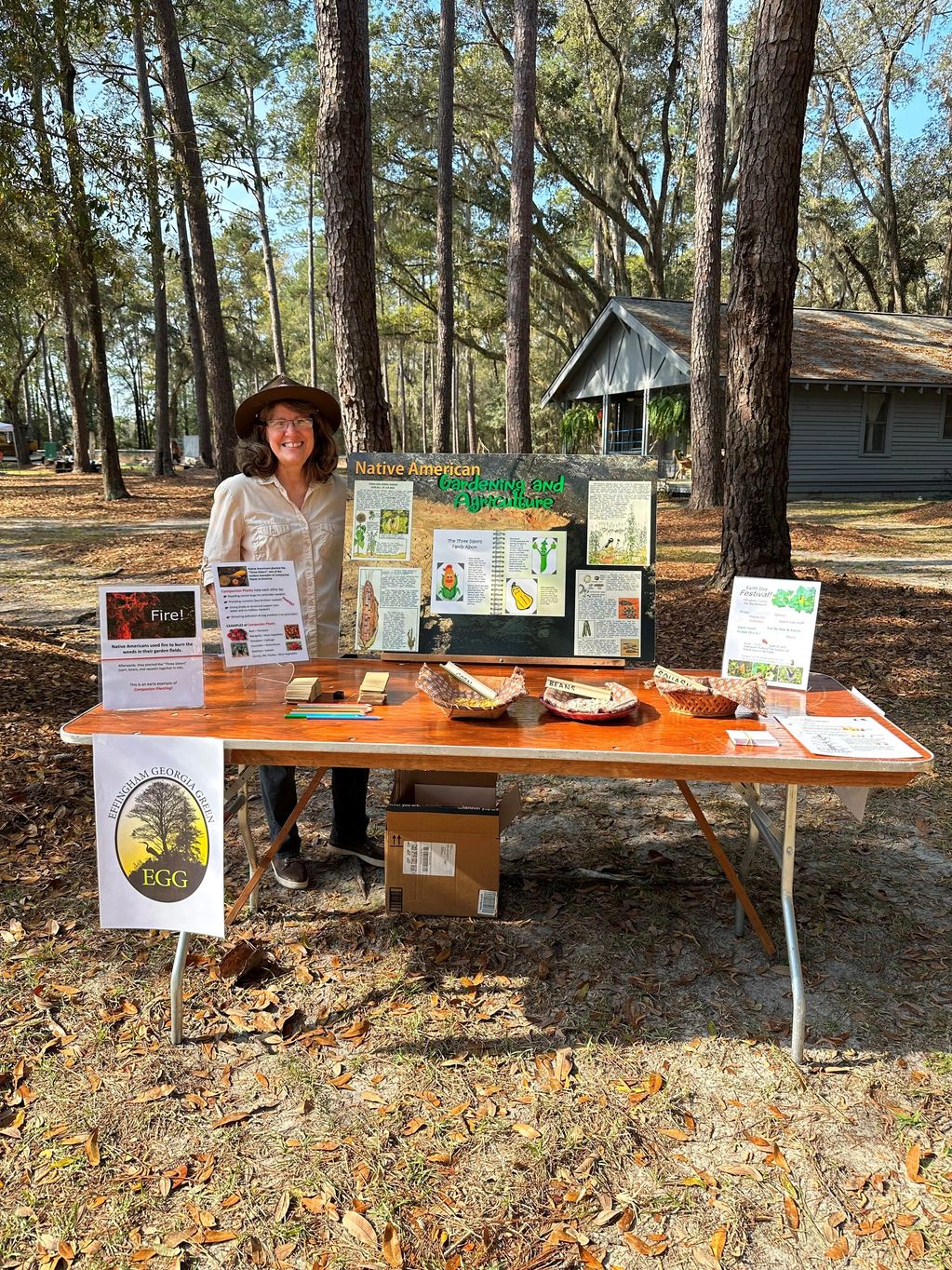 EGG person teaching about companion planting, fire and Native American gardens at a community event.