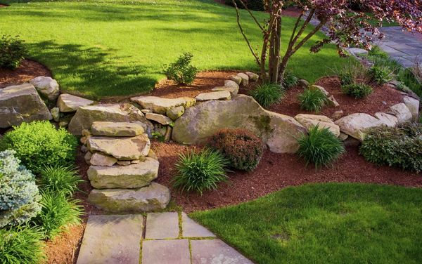 A contemporary garden 
with boulder steps, clean lines, and simplistic  uncluttered plantings.