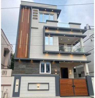 Modern three-story house with gray and wood accents.