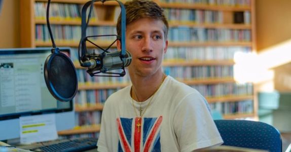 DJ Ethan Burnz spinning party tunes for the radio, WUAG 103.1 FM