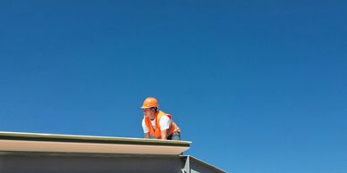 A man inspecting a roof
