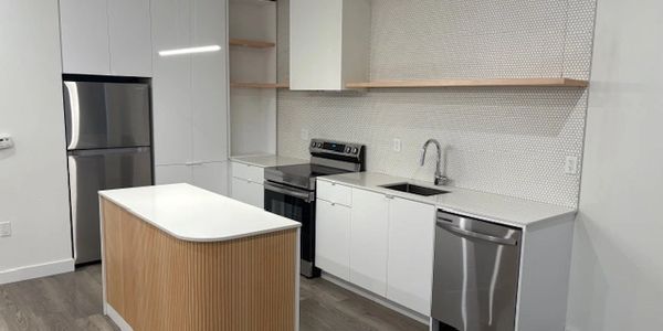 Modern minimalist kitchen with wooden island.
