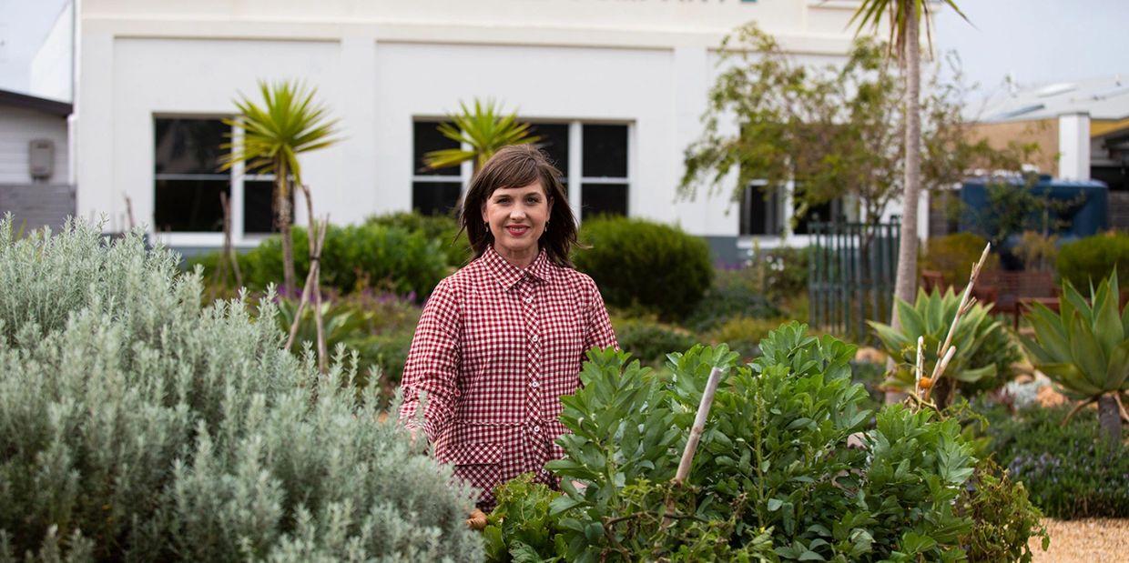 Butcher Girl Alison Meagher stands in country Victoria, Australia amongst native plants 