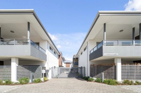Modern townhouses with gated entrance.
