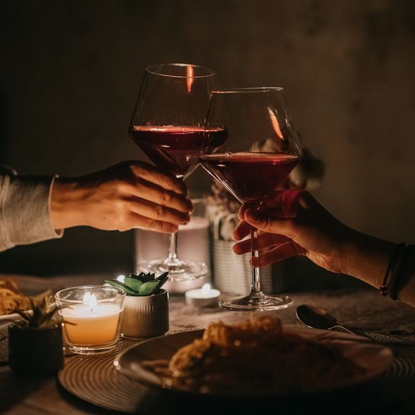 Couple holding wine glass, toasting at restaurant after ordering with a Smart Tech Menu Digital Menu