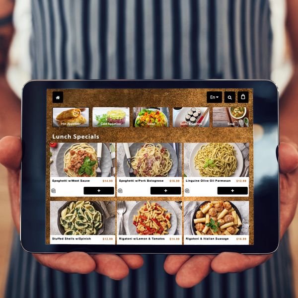 Waiter holding a Smart Tech Menu Digital Tablet Menu. Waiter holding a tablet at a restaurant.
