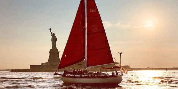 The Genesis of Narwhal Yacht Charters sailing by the Statue of Liberty!