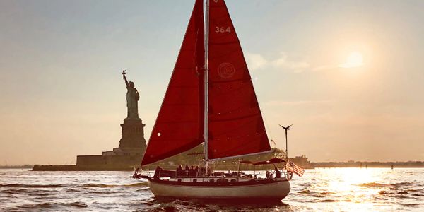 The Genesis of Narwhal Yacht Charters sailing by the Statue of Liberty!