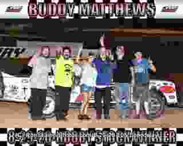 Group celebrating race car victory with trophy.