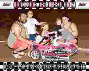 Family with a child in a toy car, smiling and posing together.