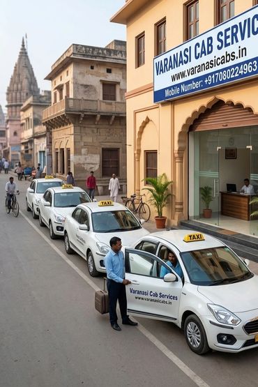 A line of white taxis from Varanasi Cab Services parked outside their office.